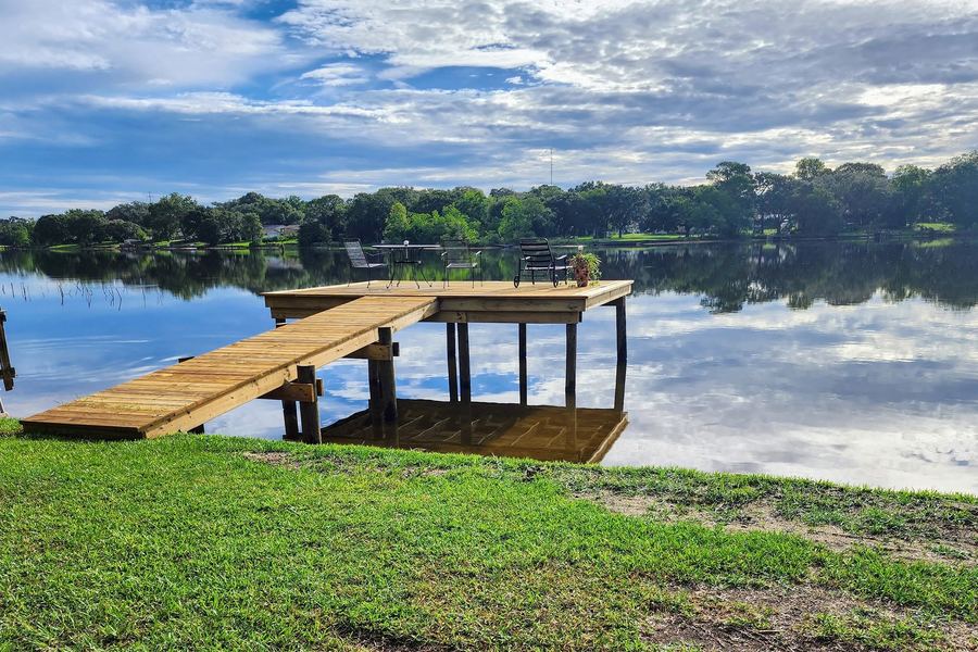 Pressure-treated dock and sitting platform over a calm lake
